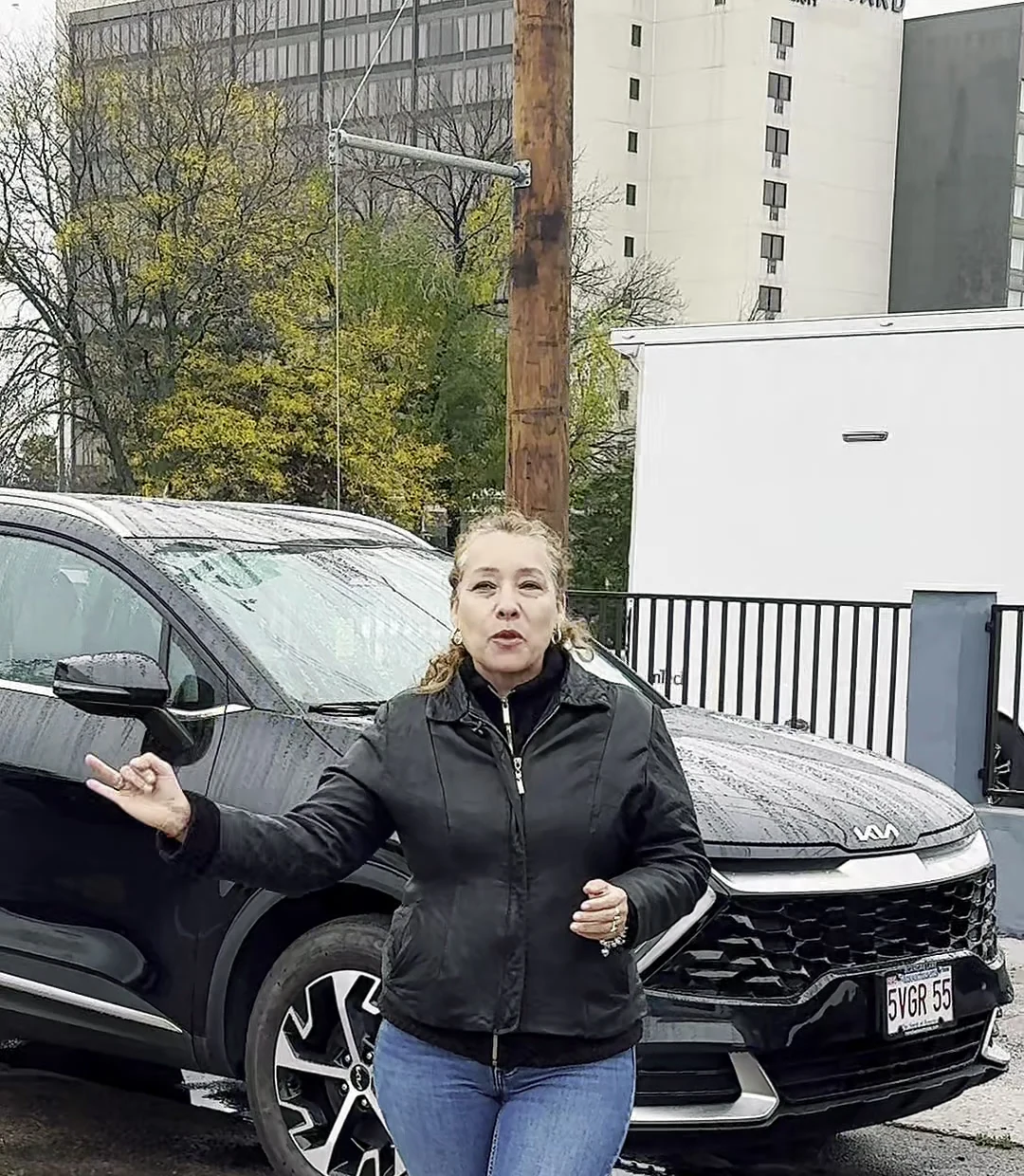 Customer standing beside her repaired vehicle